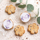 Personalised bite-size chocolate chip cookies with two round purple floral christening tags