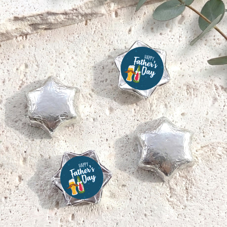Silver foil-covered chocolate stars with a blue Happy Father’s Day chocolate label