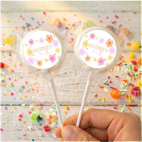 Personalized birthday daisy lollipops with Audrey 3 on clear wrapped sticks