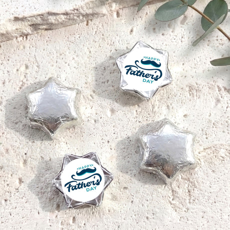 Foil-covered chocolate stars, silver foil with Happy Father’s Day label star