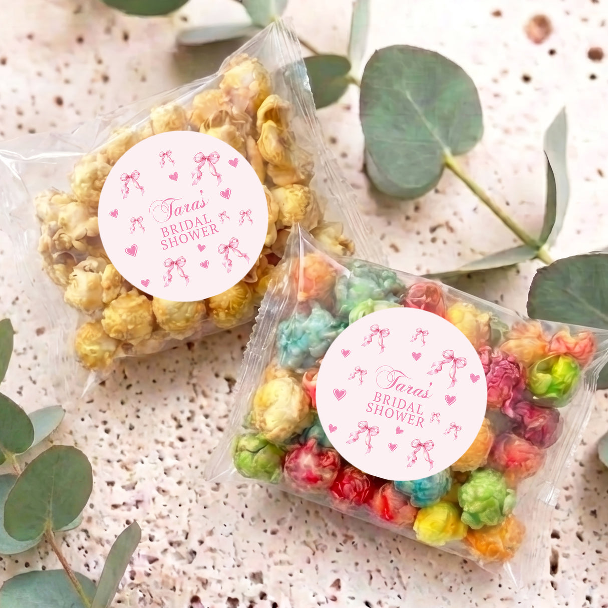 Clear popcorn bag with pink bow tie and round Tara's Bridal Shower label, rainbow popcorn