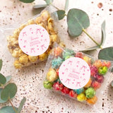 Clear popcorn bag with pink bow tie and round Tara's Bridal Shower label, rainbow popcorn