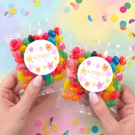 Two personalised jelly bean bags, clear pouches with daisy labels reading AUDREY