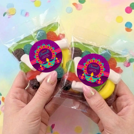 Two Diwali party mix lolly bags, each with purple Happy Diwali round sticker and candies
