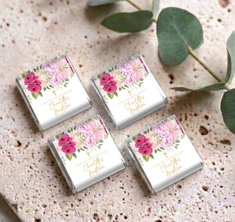 Set of personalised mini chocolate boxes with pink rose floral labels and gold cross symbols