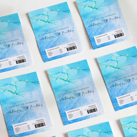 Blue 30th birthday chocolate wrappers with gold text and marbled accent lines