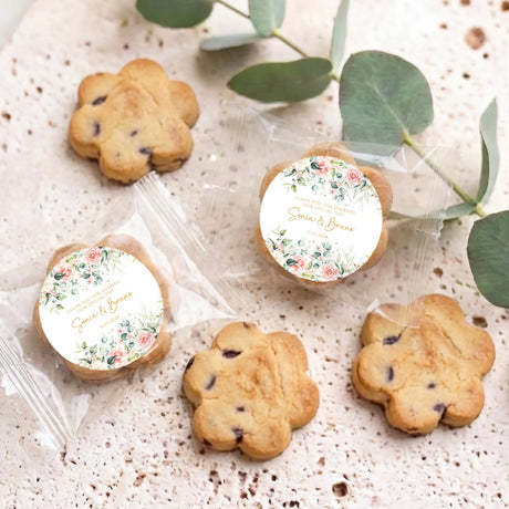 Assorted chocolate chip cookies with round floral labels, displayed on a tray