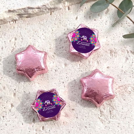 Pink foil-covered chocolate stars in star shapes with Diwali elephant label.