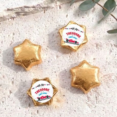 Gold foil-covered chocolate star sweets with personalized "THEODORE" label