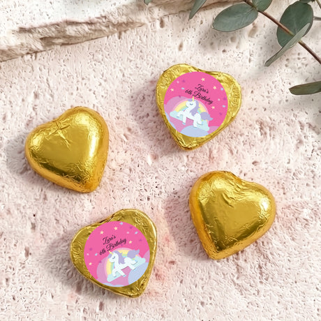 Gold foil chocolate hearts with unicorn “Zara’s 6th Birthday” label.