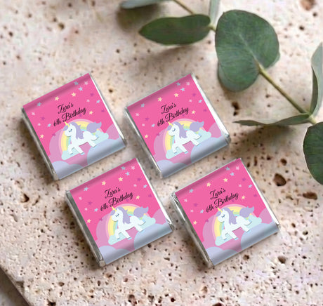 Four personalised unicorn rainbow mini chocolates with pink 60th birthday labels