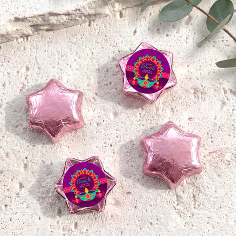 Pink foil-covered chocolate star sweets with Diwali label wrappers