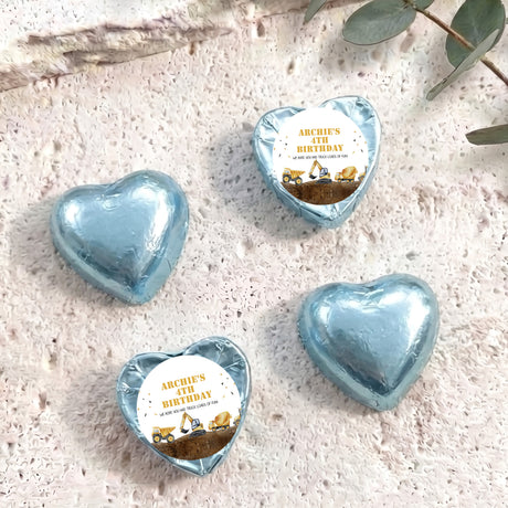 Foil-covered chocolate hearts in light blue with birthday label featuring a construction truck
