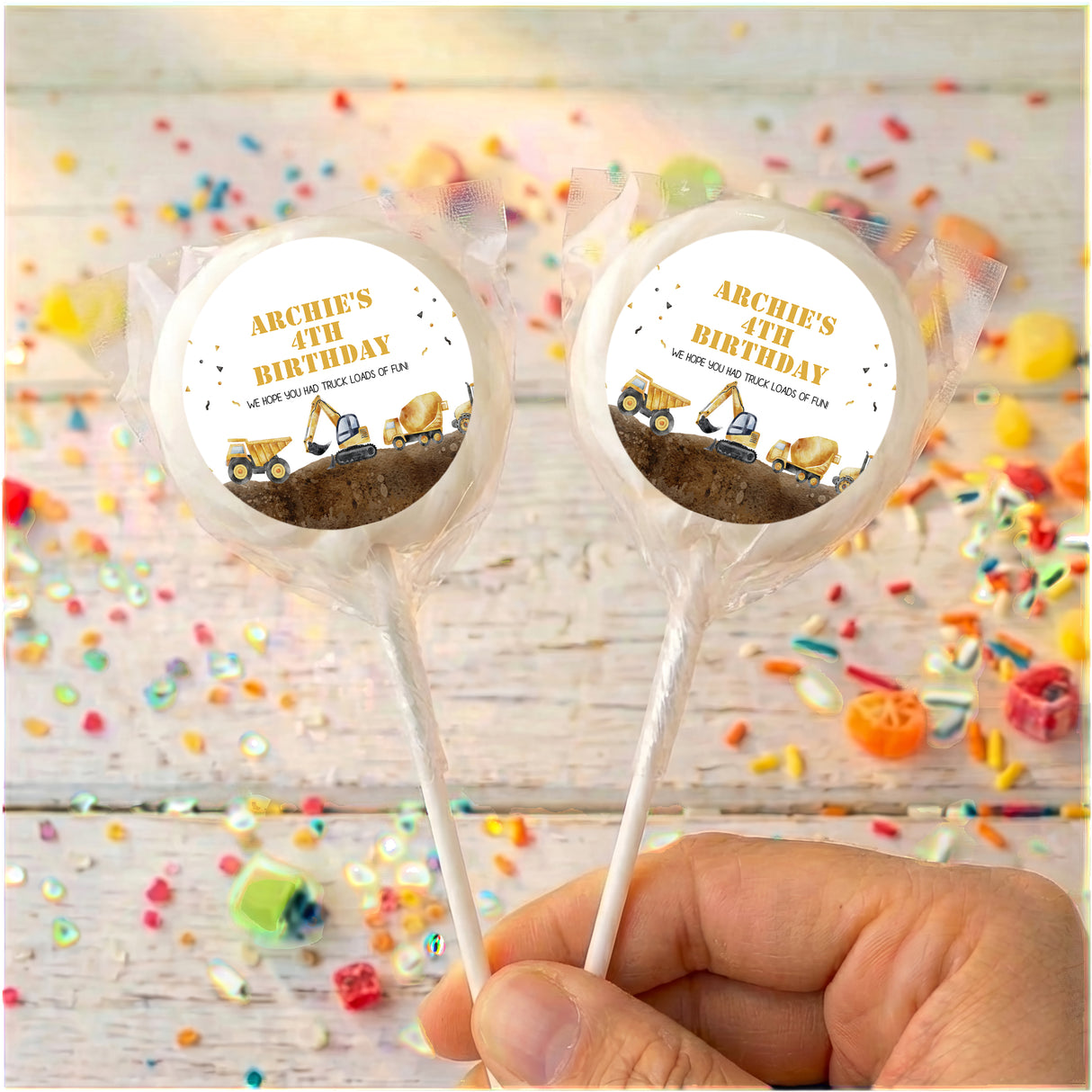 Personalised lollipops with ARCHIE'S BIRTHDAY truck labels, two clear-ring sticks