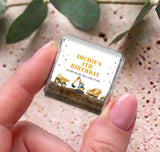 Mini chocolate wrapper held in fingers: “Archie’s 4th Birthday” with construction truck graphic