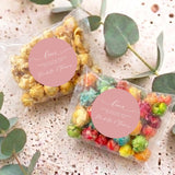 Two personalised popcorn bags in clear wrap with round pink 'Love' labels