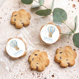 Set of bite-size cookies with blue hot air balloon first birthday labels