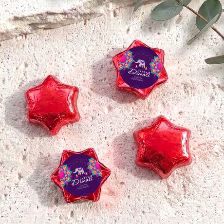 Red foil-covered chocolate stars in star shapes with Diwali elephant label.