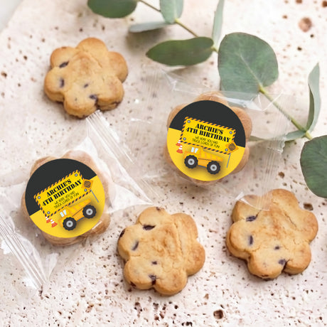 Bite-size chocolate chip cookies with two truck birthday stickers on cookies