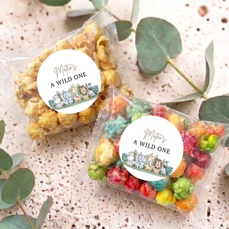 Personalised popcorn bags with circular 'A WILD ONE' labels, assorted colored popcorn