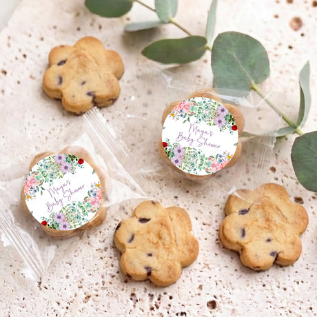 Tray of bite-size choc chip cookies with two floral round “Maya’s Baby Shower” labels