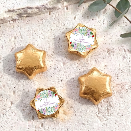 Gold foil-covered First Holy Communion chocolate stars with floral personalised labels