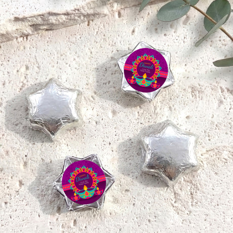 Silver foil-covered chocolate star sweets with Diwali label wrappers