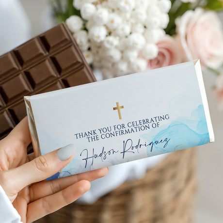 Confirmation chocolate bar wrapper, white with blue marble waves and gold cross