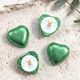 Green foil-covered heart chocolates with printed center, first birthday design