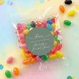 Clear jelly bean favor bag with colorful beans and sage green 'Love' round label