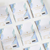 Blue and gold baptism chocolate wrapper set with watercolor leaves, cross, text, barcode.
