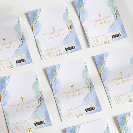 Blue and gold baptism chocolate wrapper set with watercolor leaves, cross, text, barcode.