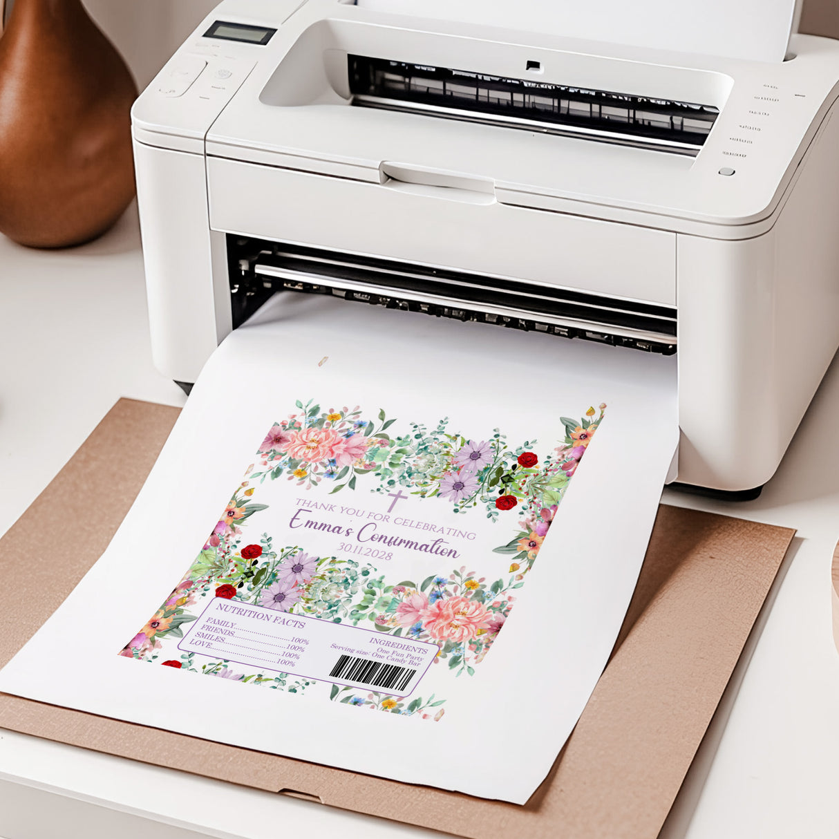 Chocolate bar wrapper print sheet with floral design coming out of a printer