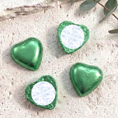 Green foil-covered chocolate hearts with heart-shaped foil wrap and white label