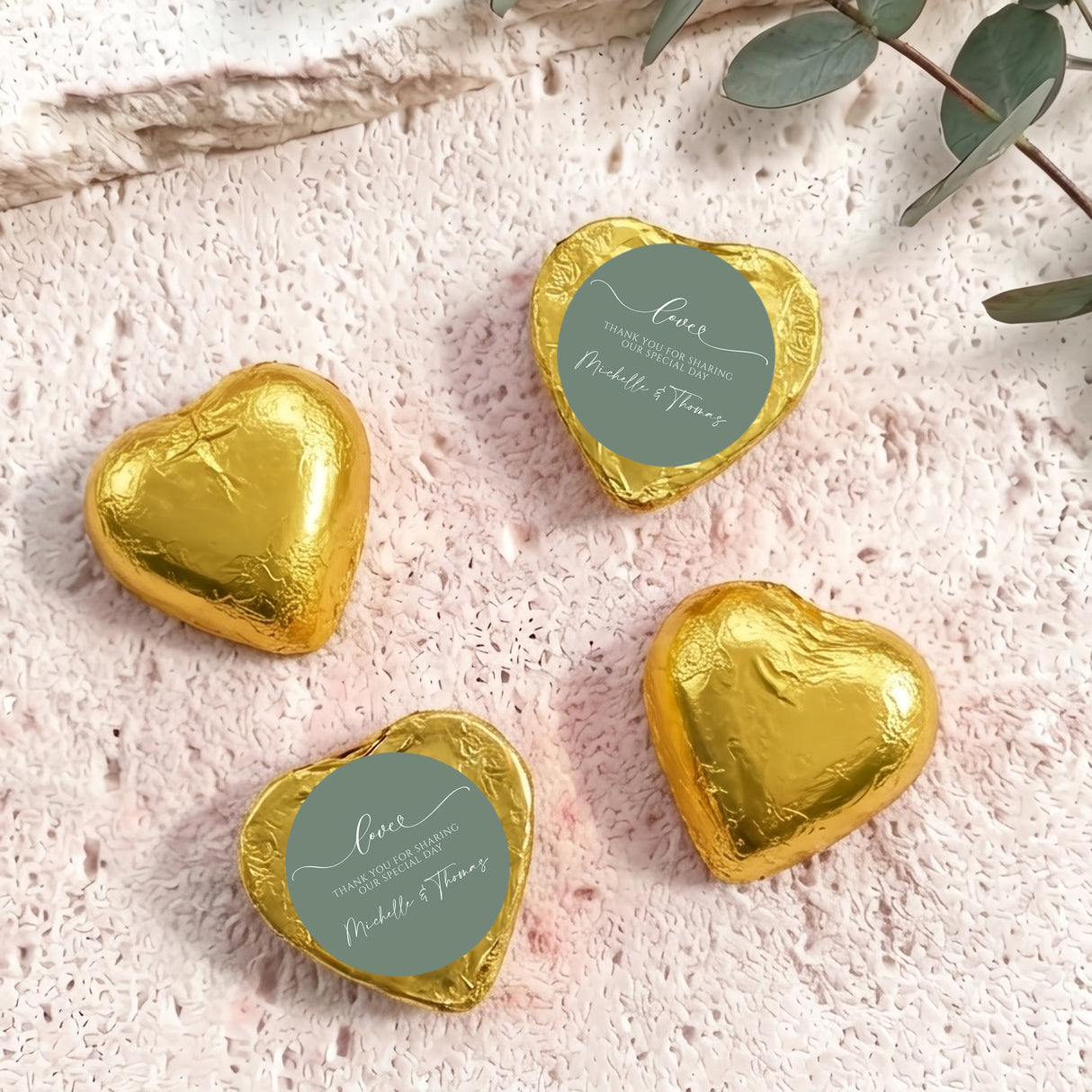 Gold foil-covered heart chocolates with round personalized thank-you labels
