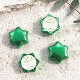 Foil-covered chocolate stars in green with floral confirmation label