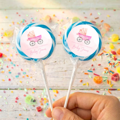 Personalized baby shower lollipops with light blue carriage labels on clear wrappers