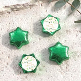 Green foil-covered chocolate stars with a round personalized label on each piece