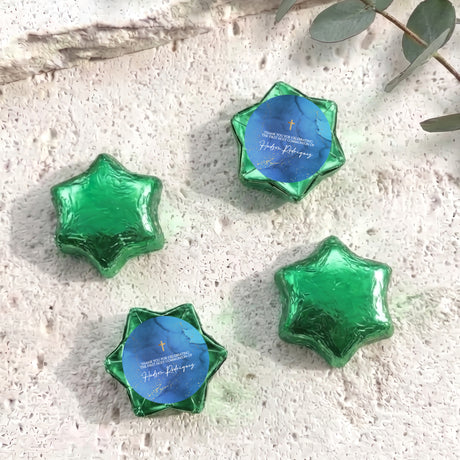 Green foil chocolate stars with blue personalised label and gold cross detail