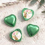 Green foil-covered chocolate hearts with floral wrapped center medallions