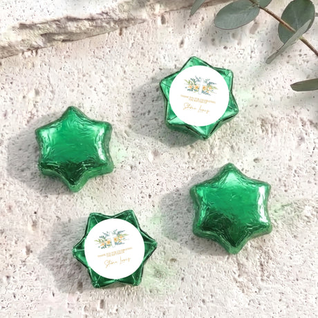 Green foil-covered chocolate stars with round label inserts