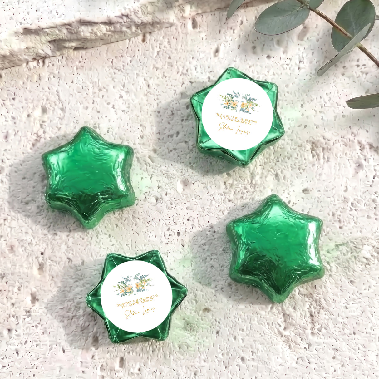 Green foil-covered chocolate stars with personalised circular cross label in each star wrapper