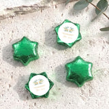 Green foil-covered chocolate stars with personalised circular cross label in each star wrapper