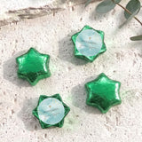 Foil-covered green chocolate stars with white cross and personalised message card