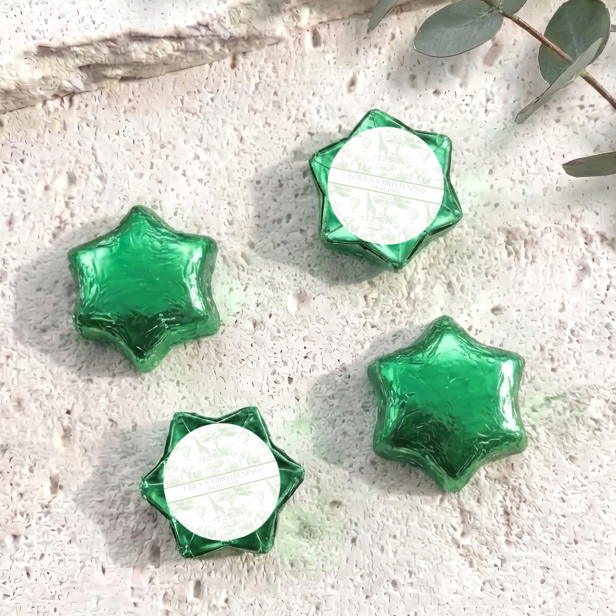 Green foil-covered chocolate stars with white center labels, arranged in a cluster.