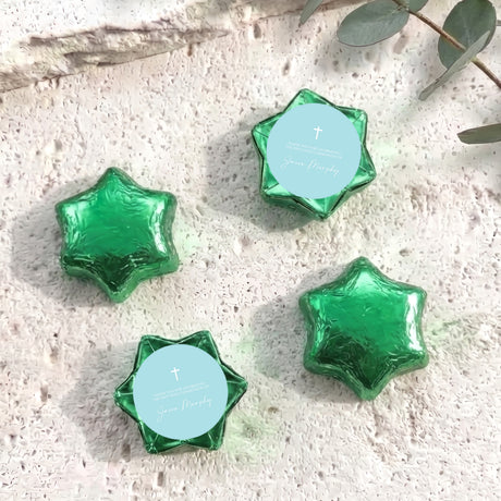 Green foil-covered chocolate stars with cross medallion labels