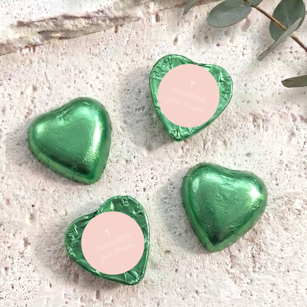Green foil heart chocolates with cross and personalised text on pale label.
