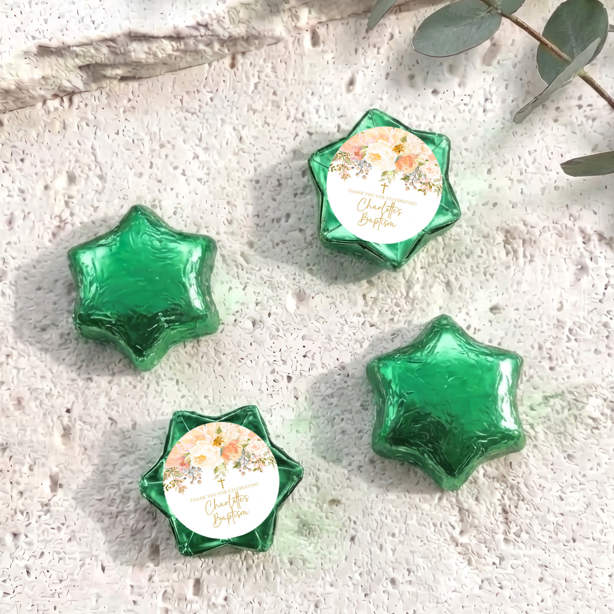 Foil-covered chocolate stars in green tones with a floral personalisation label