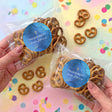 Personalised pretzel bag with blue seal and gold cross, sealed pretzels inside