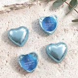 Foil-covered chocolate hearts with blue wrappers and gold cross design